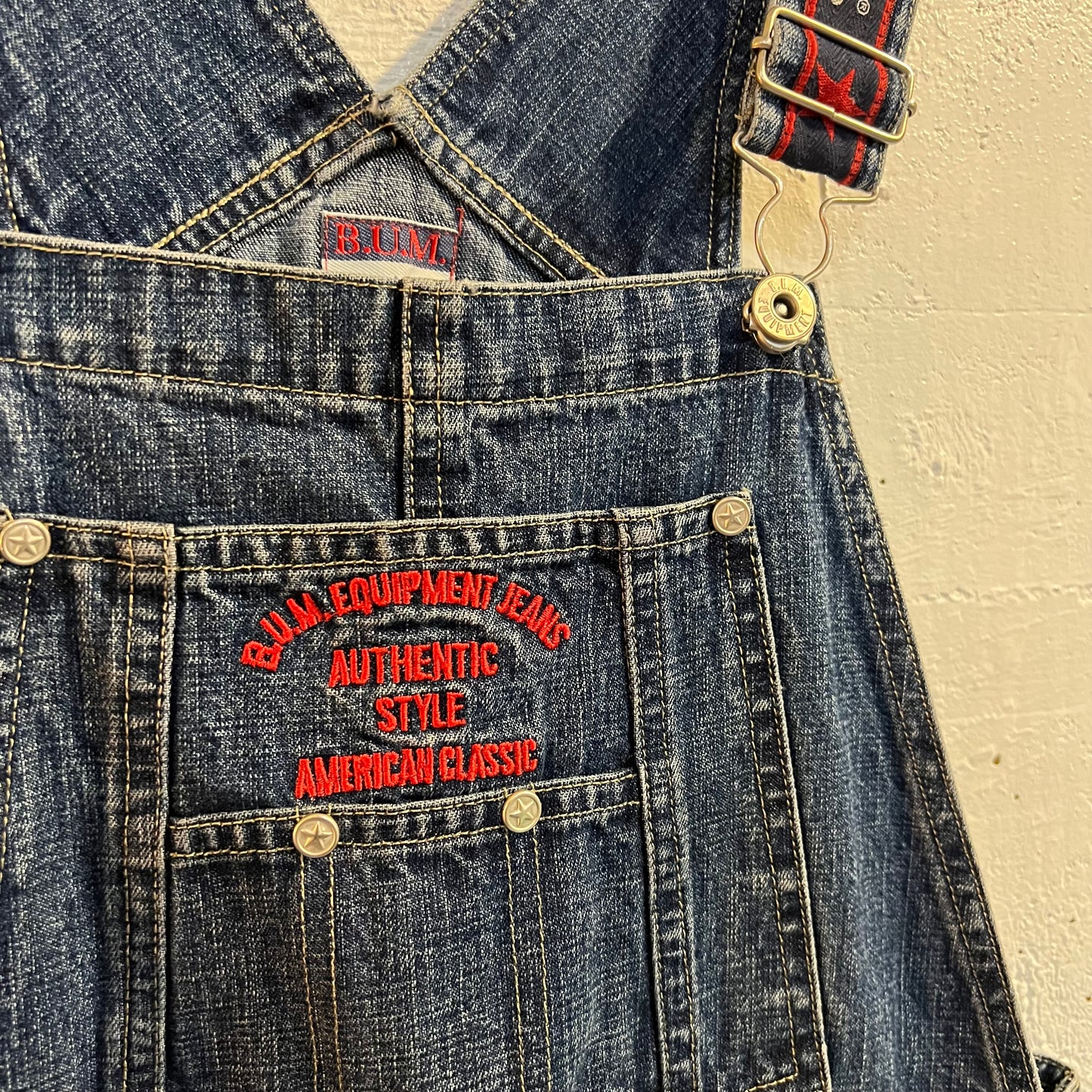 Vintage 90's B.U.M. Equipment Embroidered Spellout Denim Short Overalls - Size Small - Medium Wash Indigo